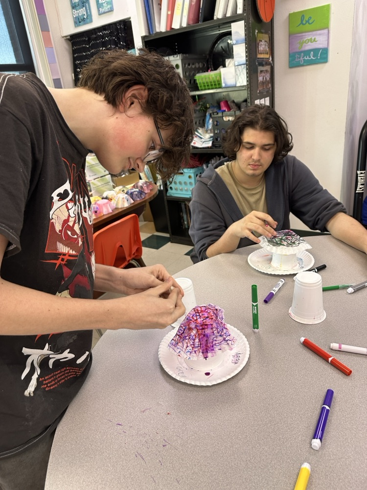 Students in the Tiger Success Center crafting ghosts made from coffee filters.