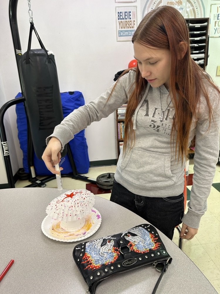 Students in the Tiger Success Center crafting ghosts made from coffee filters.
