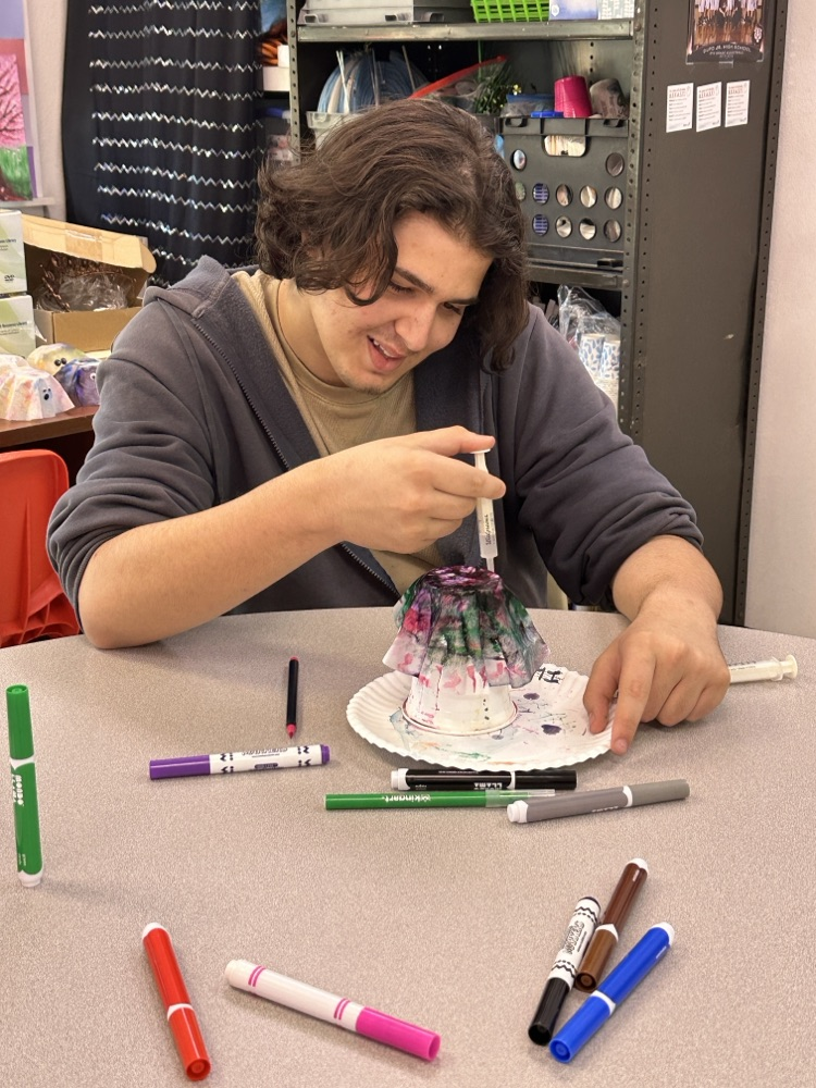 Students in the Tiger Success Center crafting ghosts made from coffee filters.