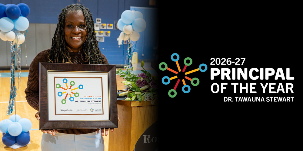 Dr. Tawauna Stewart smiles while holding her 2026–27 Principal of the Year award at a school celebration with blue balloons and flowers.