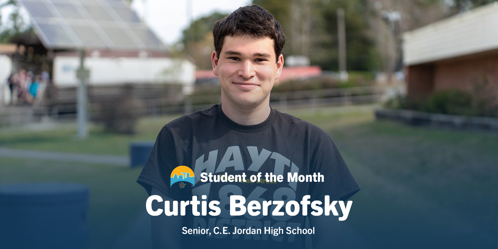 A young man stands outside with a slight smile, wearing a casual T-shirt. Text reads "Student of the Month, Curtis Berzofsky, Senior, C.E. Jordan High School."