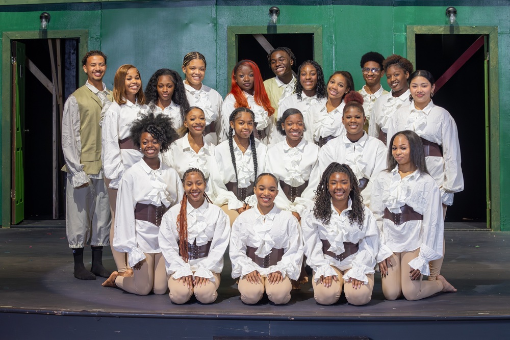 student dancers in colonial costume posing on a stage