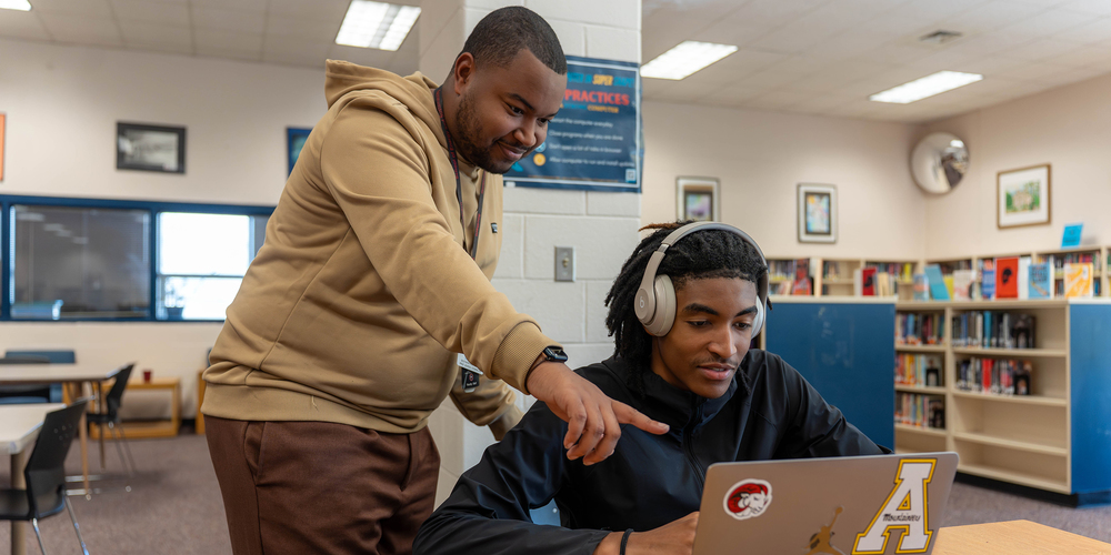 Counselor working with student on computer