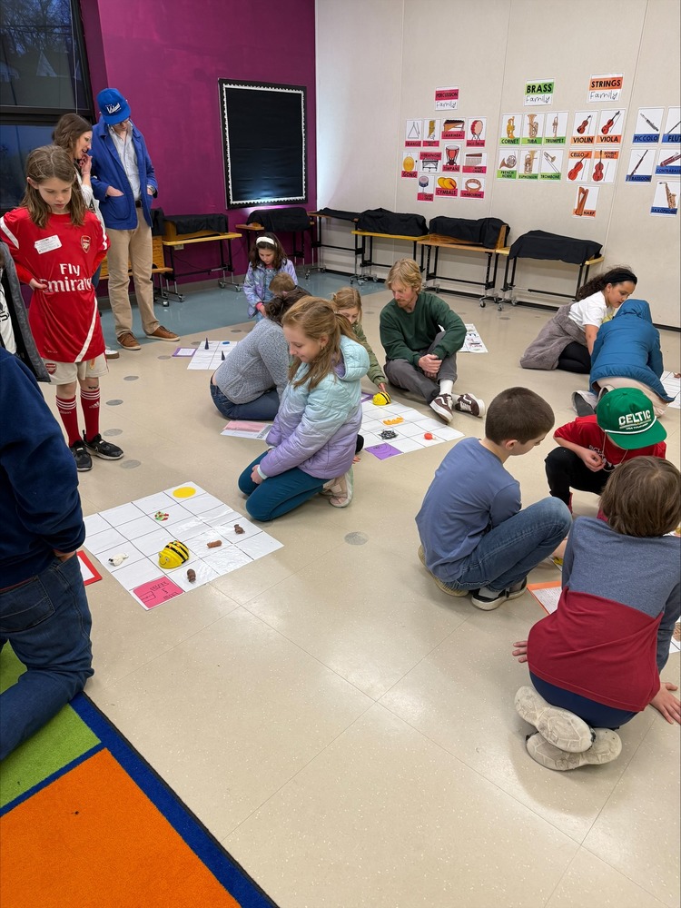 Students using robots during a family event.