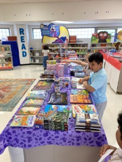 Student looks at books at book fair