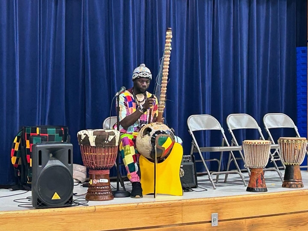 Diali story teller and African musician playing with traditional instruments
