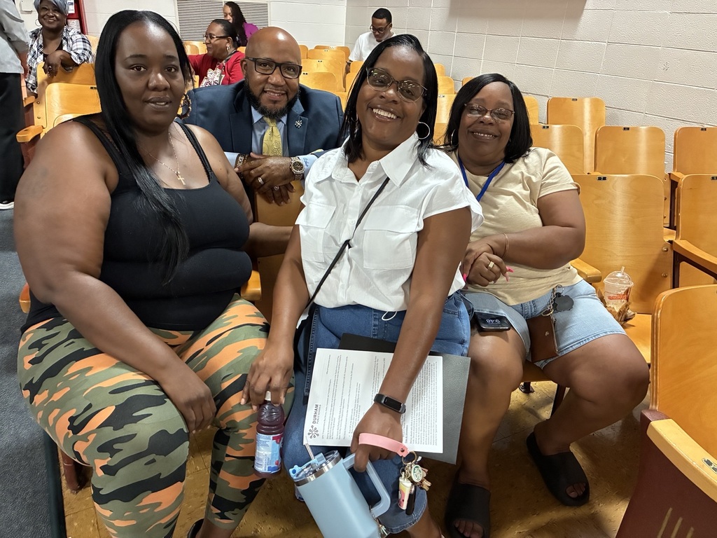 Bus drivers taking photo with superintendent