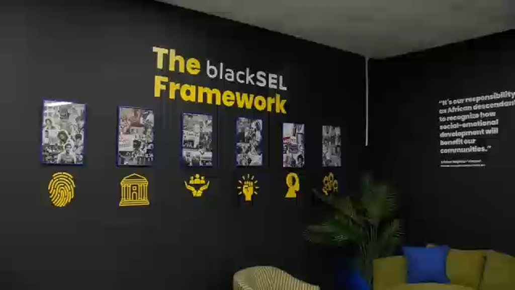 Black wall with casual furniture in front labeled The blackSEL Framework