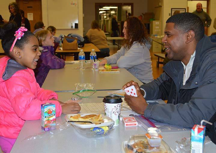 Dad and daughter eating breakfast.