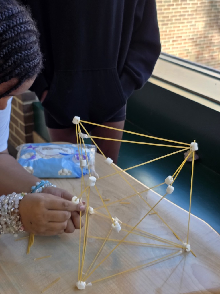 Students used spaghetti and marshmallows to design and build towers—testing how one variable proportionally affects another while applying evidence from the text to guide their decisions. The room was filled with collaboration, problem-solving, and lots of creative engineering!