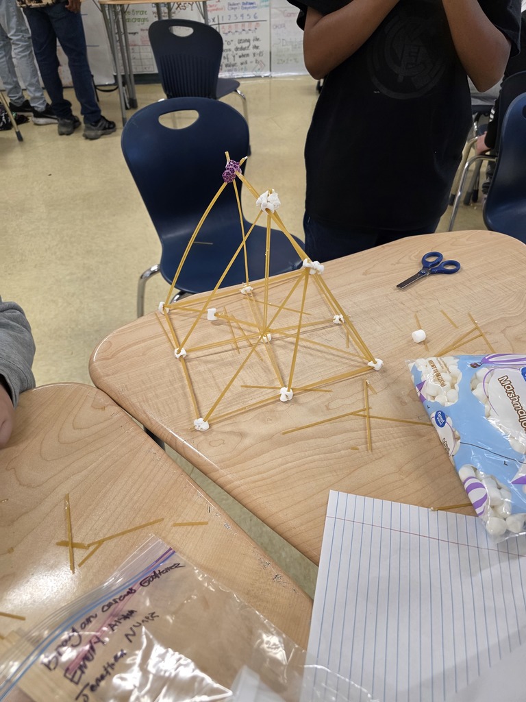 Students used spaghetti and marshmallows to design and build towers—testing how one variable proportionally affects another while applying evidence from the text to guide their decisions. The room was filled with collaboration, problem-solving, and lots of creative engineering!