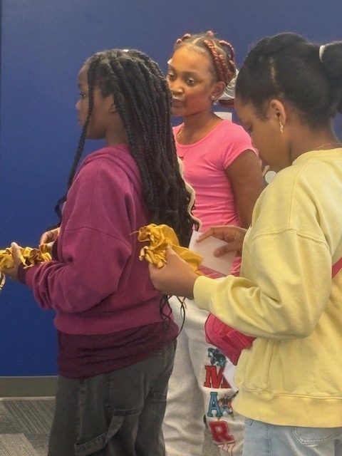 5th Grade students distributing Pauli Murray quarters to everyone in attendance