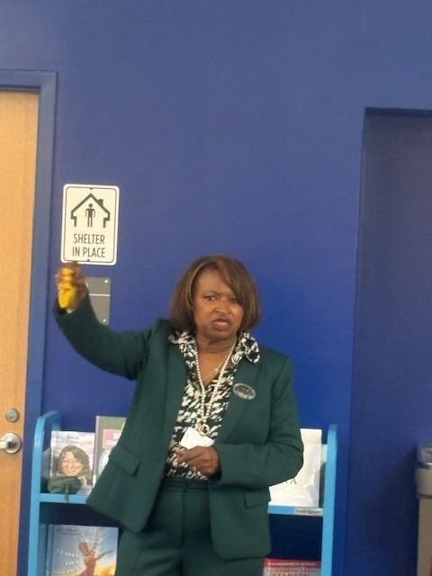 Dr. Arrington explaining the gift she secured for everyone - Pauli Murray quarters