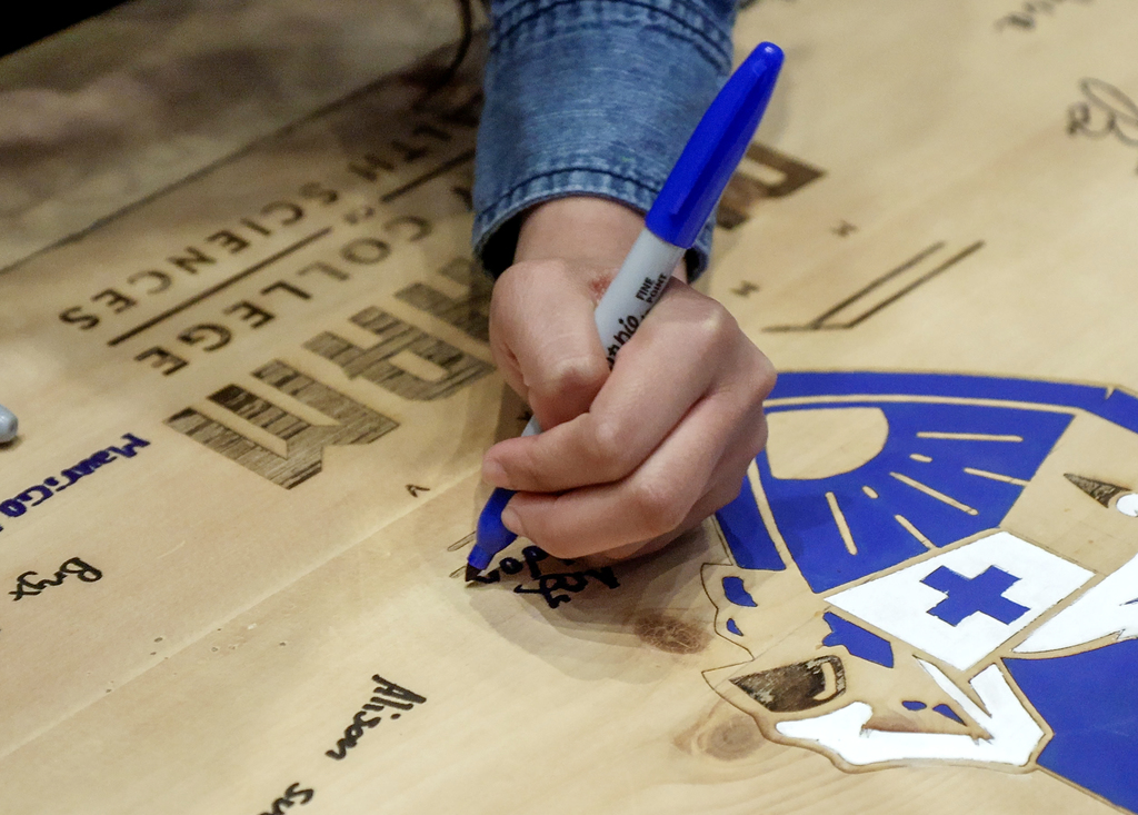Student signing the Signing board.