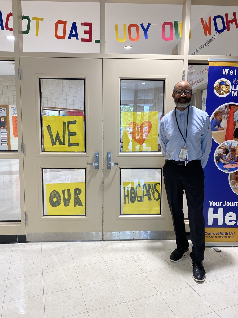 Dr Hogans in front of We Love you signs