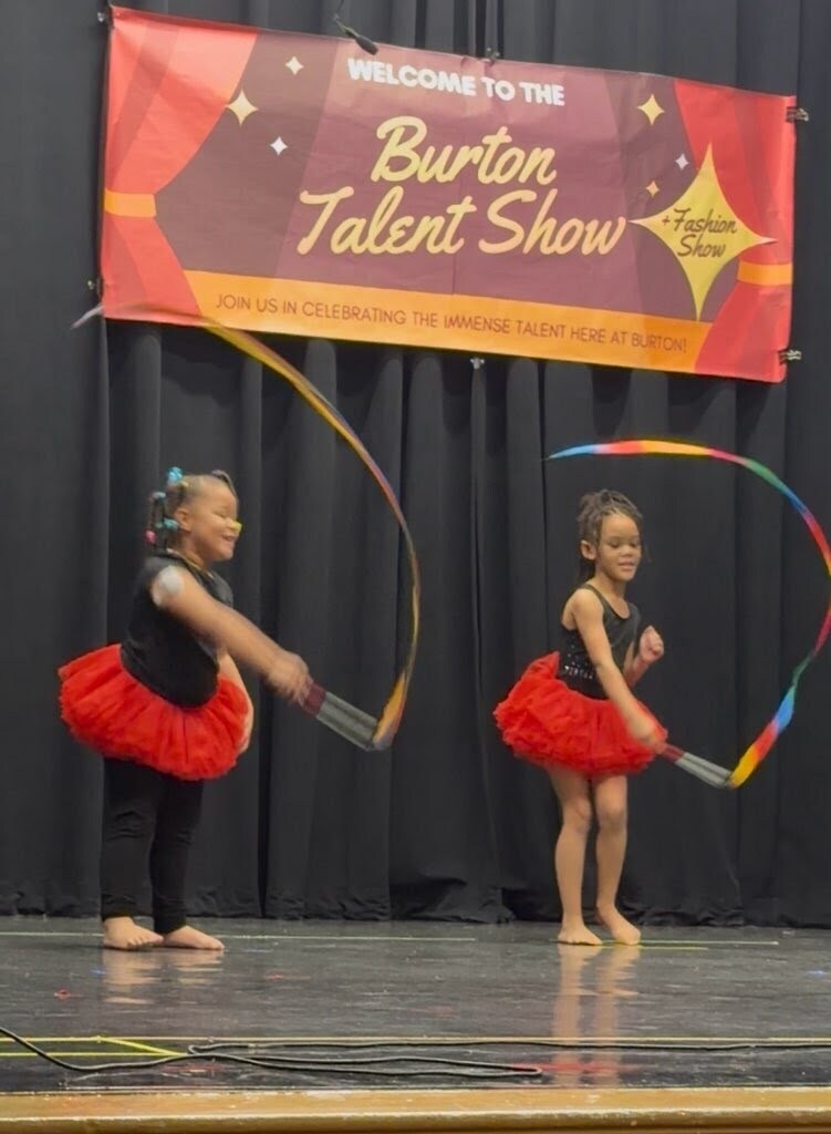 Two girls performing with colorful ribbons