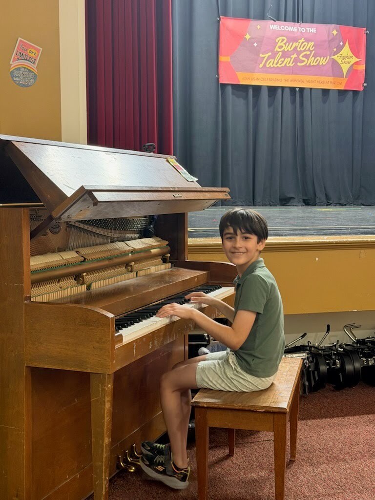 A boy playing the piano
