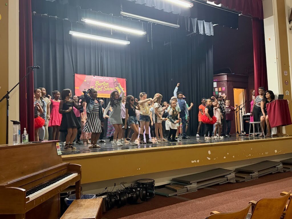 A group of students dancing on stage