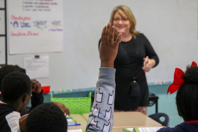 Teacher calling to student raising hand