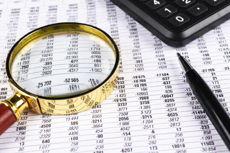 magnifying glass focused on numbers on paper