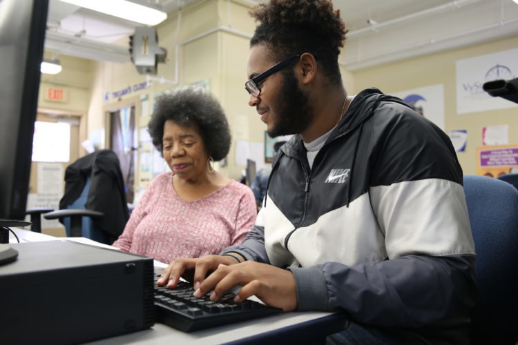 Student with grown woman on computer