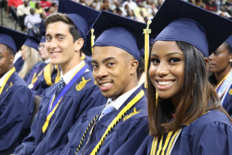 Students at a graduation ceremony, wearing graduation caps and gowns