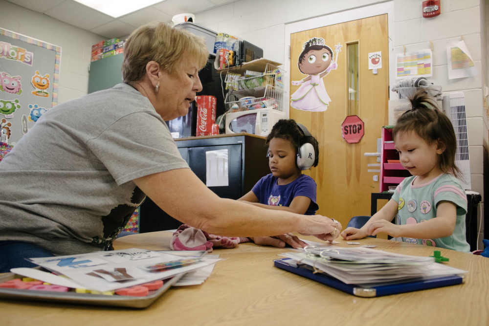 Teacher helping students with work