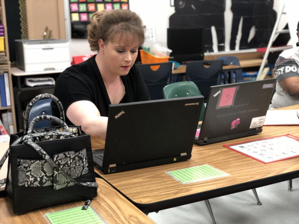 Teacher using her laptop, on desk