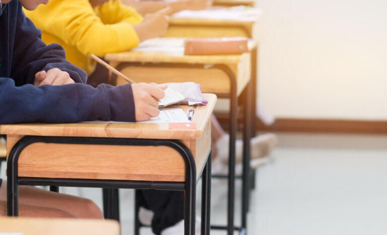 student answering a test on desk