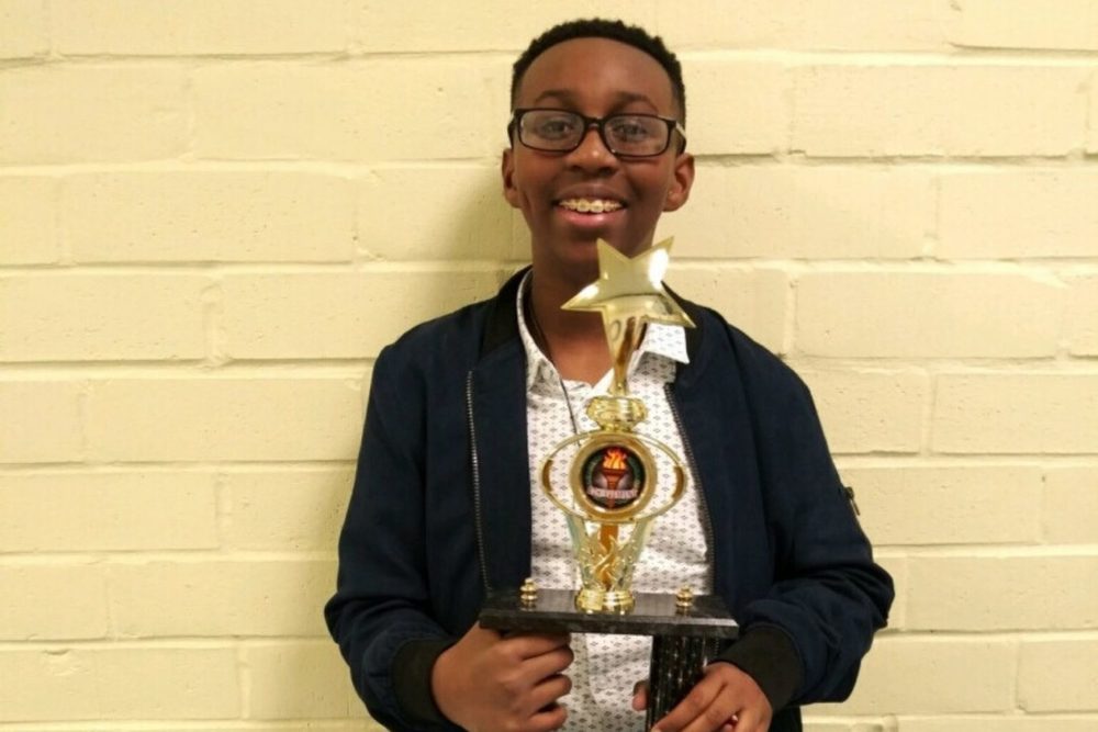 Student holding trophy