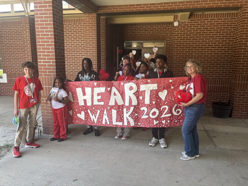 John E. Ford students and Principal Bennett holding "Heart Walk 2026" sign
