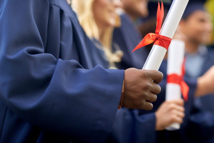 Image of students holding a diploma