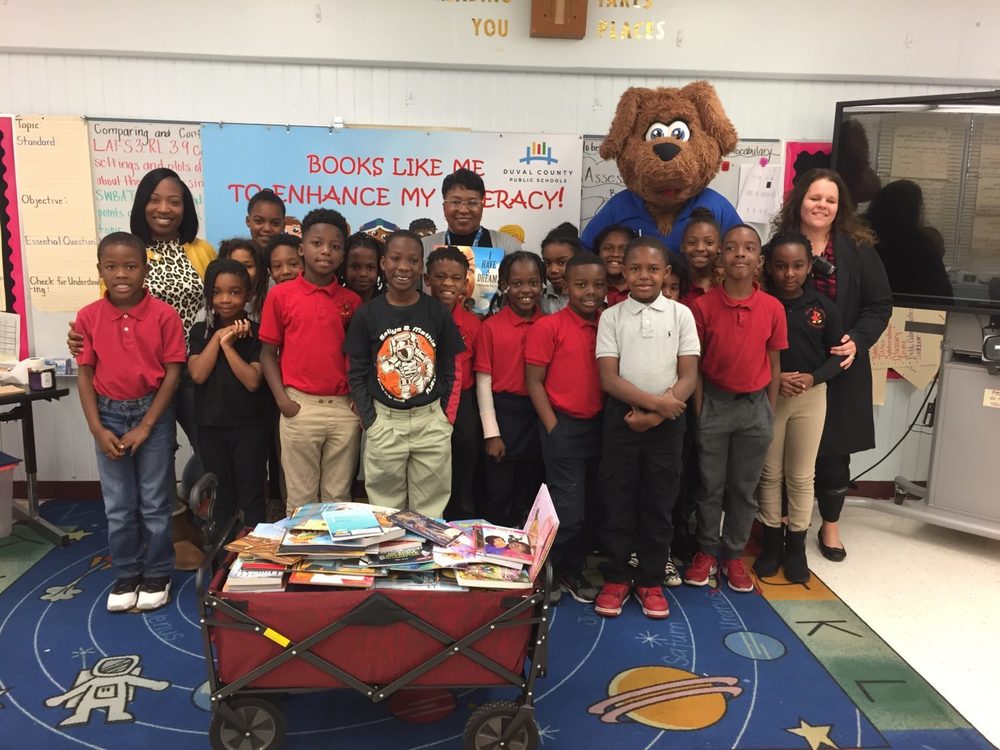 Students standing with dog mascot.
