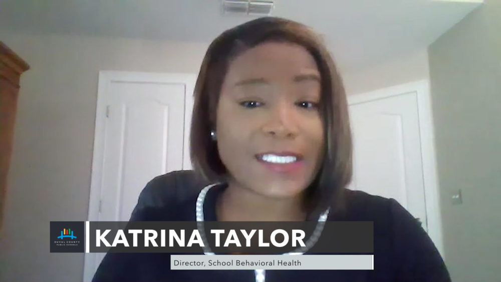 Director of school looking at camera videotaping.