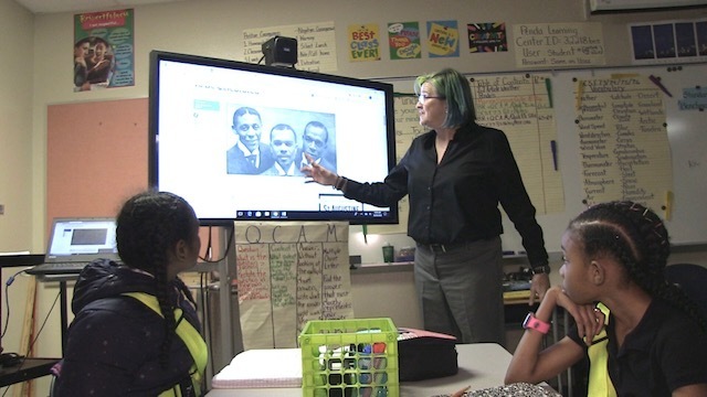 Teacher, teaching with video on tv