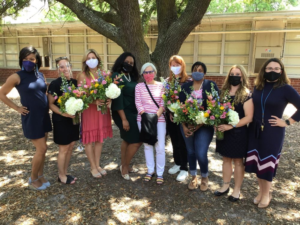 group of 9 women with flowers
