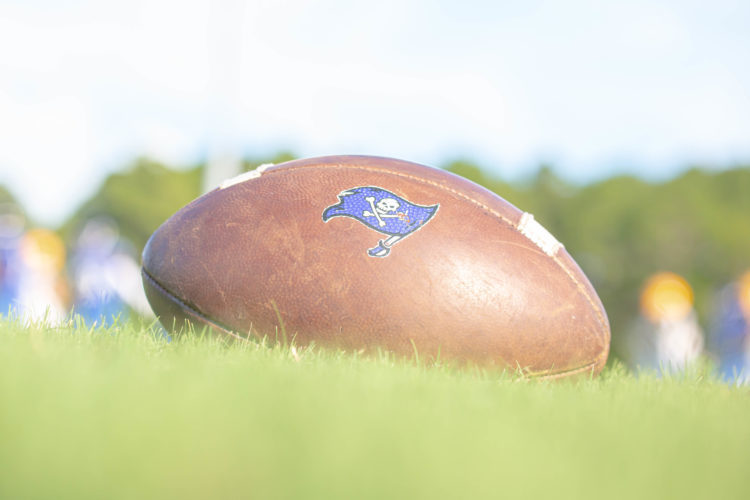 Up close image of a football with a prirate's flag on it. 