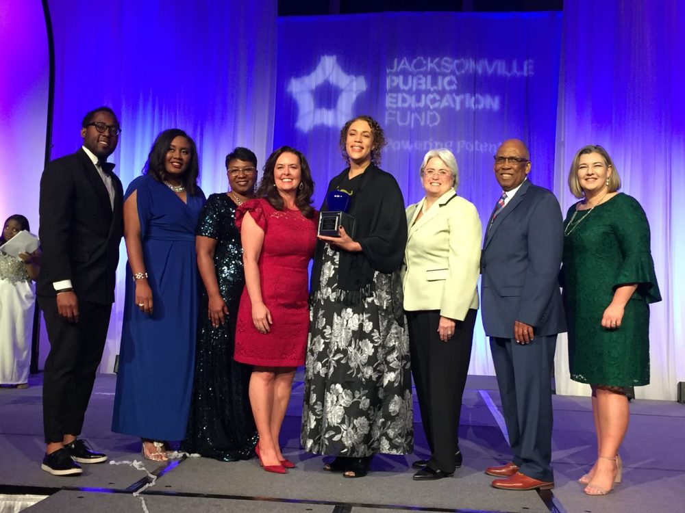 People posing with an award