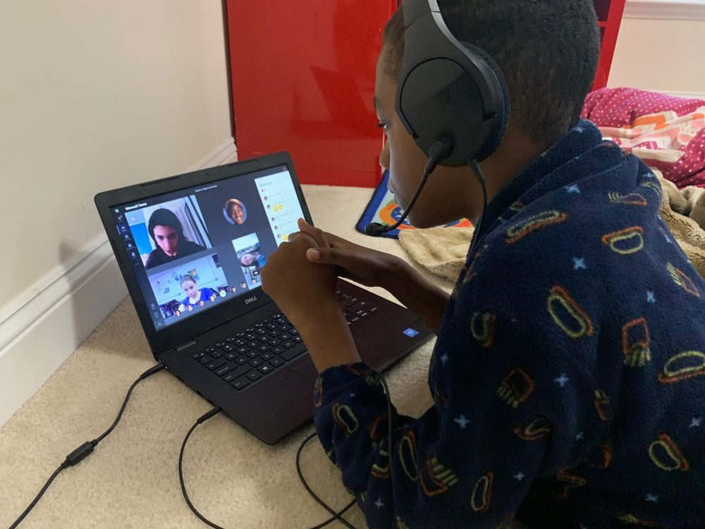 Student staring at laptop, in zoom meeting
