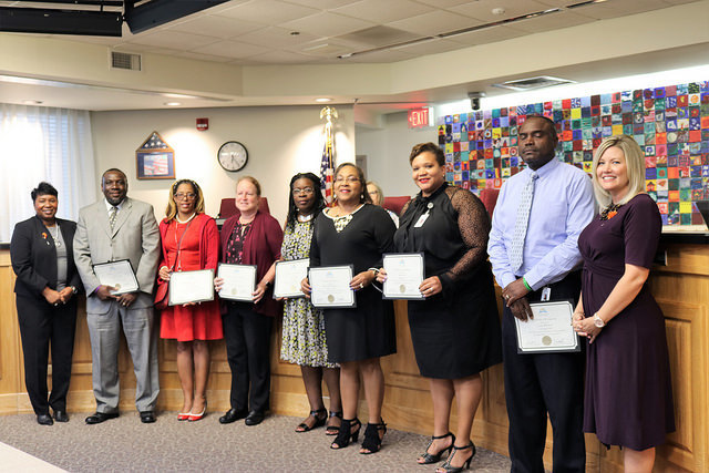 9 teachers receiving a diploma