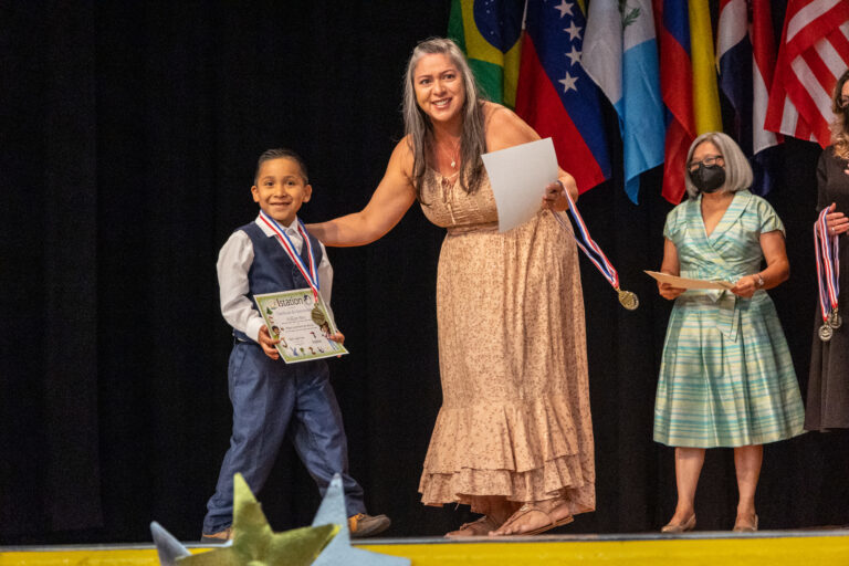 Student receiving diploma on stage