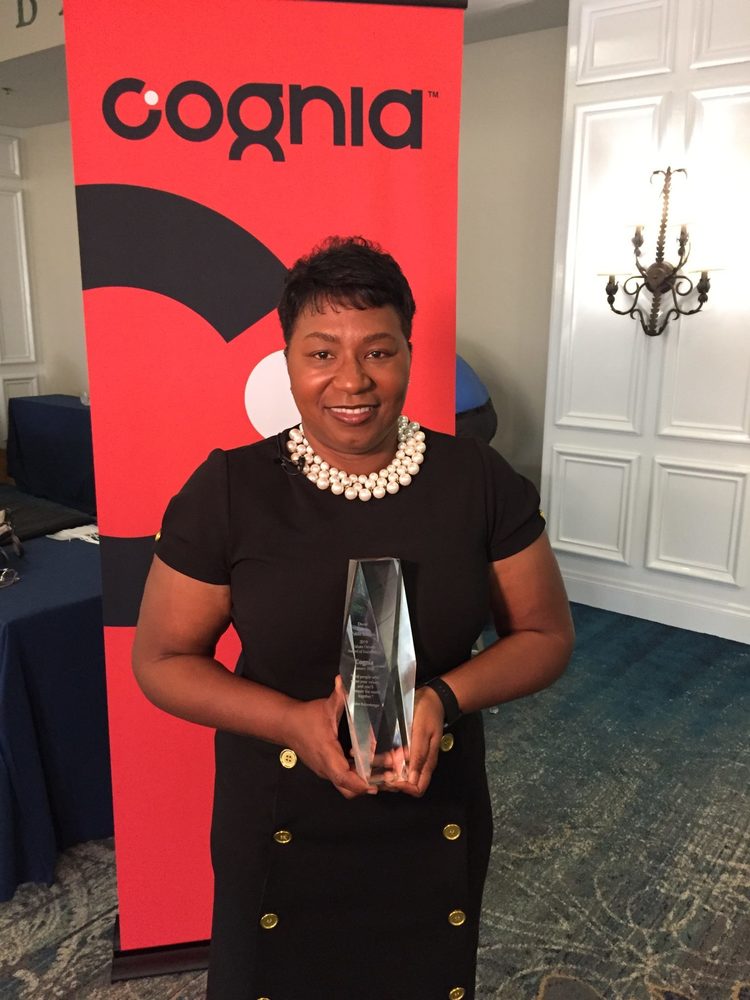 Teacher posing with award