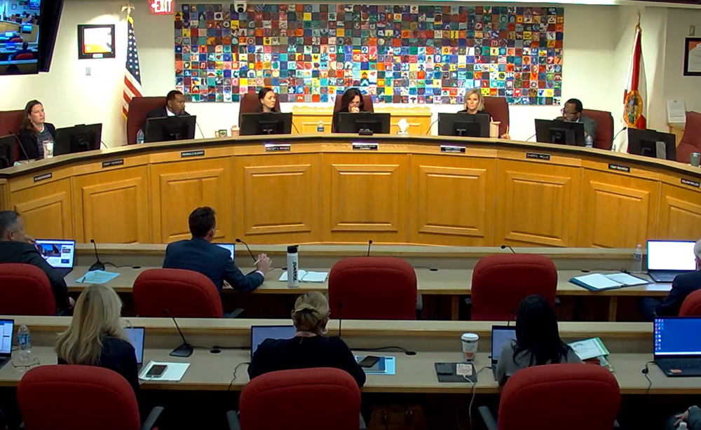 Screenshot of Board members sitting at dais during the December School Board meeting