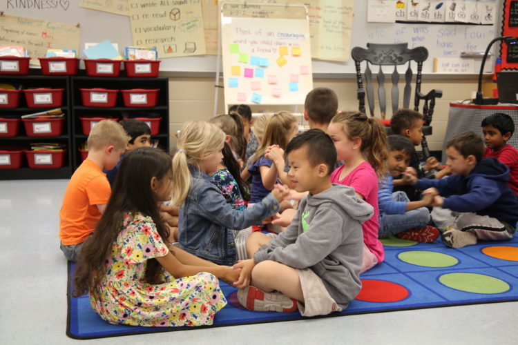 Little kids playing on a mat