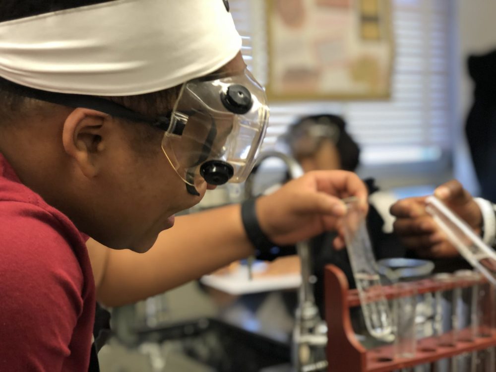 Student wearing goggles in science class.