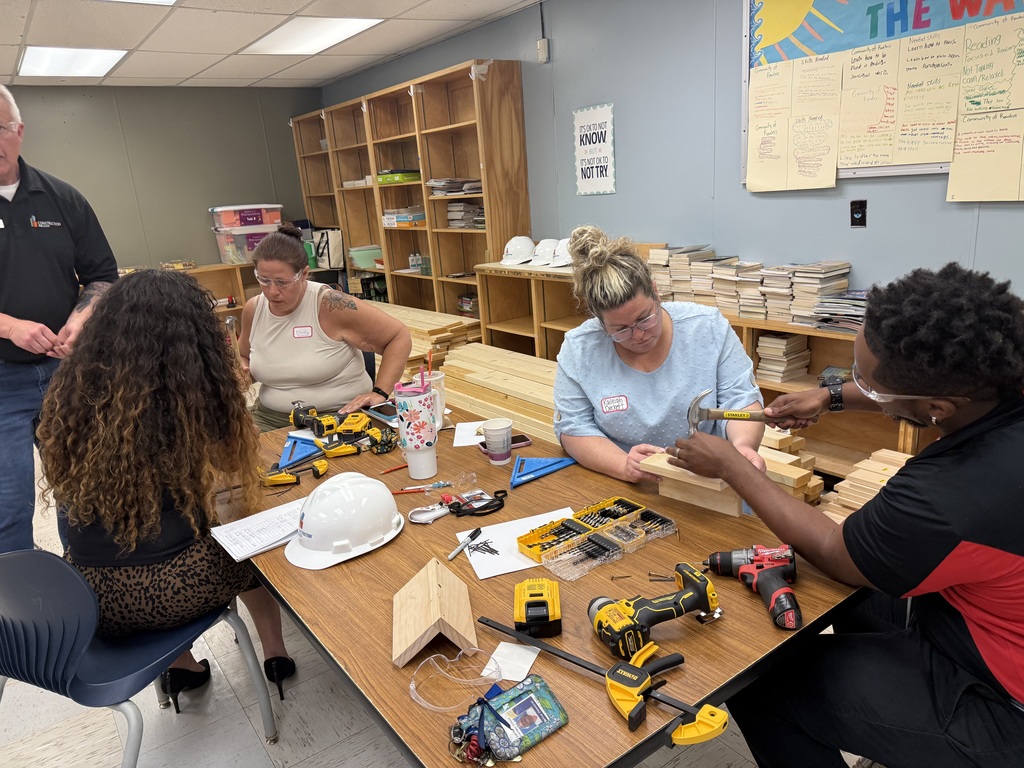 Our teachers are learning the best technique for hammering nails