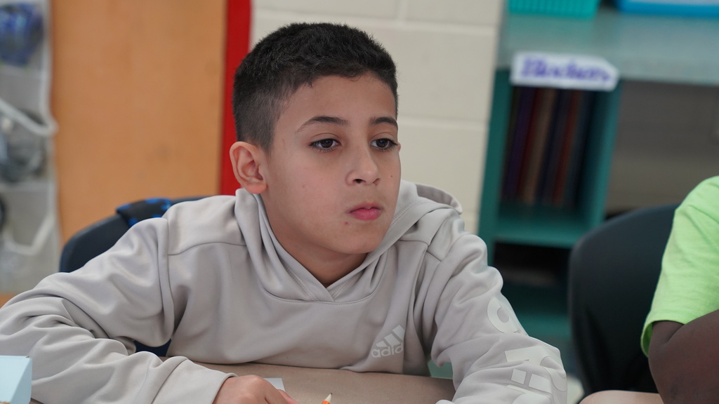 Lori Matthews smiles while leading a math activity in her 5th grade classroom at San Jose Elementary, surrounded by engaged students.