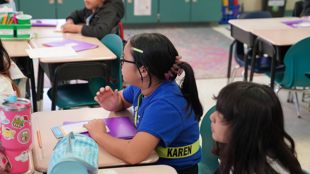 Lori Matthews smiles while leading a math activity in her 5th grade classroom at San Jose Elementary, surrounded by engaged students.