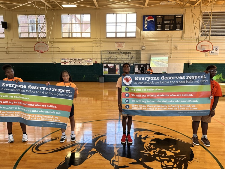 students holding bullying prevention banner