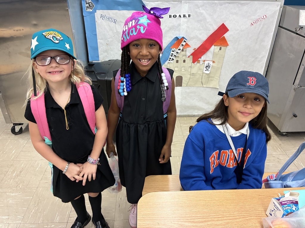 students posing with hats on